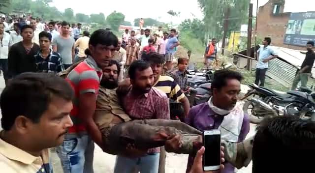 People were seen carrying a wounded out from under the over bridge.