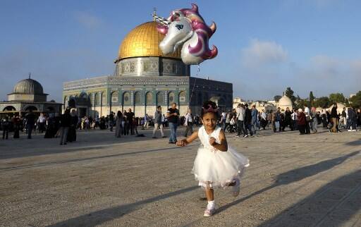 Palestine: A young girl flies a helium balloon near the Dome of the Rock at al-Aqsa Mosque compound in Jerusalem’s old city on the first day of Eid al-Adha. /Image: AFP, Ahmad Gharabli 