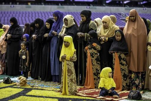 US: Women and children pray during worship services as the US Bank Stadium. /Image: AFP, Kerem Yucel