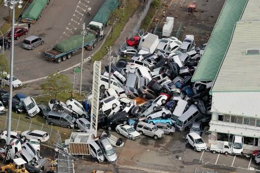 An aerial view from a Jiji Press helicopter shows vehicles piled in a heap due to strong winds in Kobe, Hyogo prefecture.
The toll in the most powerful typhoon to hit Japan in a quarter century rose on September 5 to nine, with thousands stranded at a major airport because of storm damage. / IMAGE: AFP PHOTO / JIJI PRESS