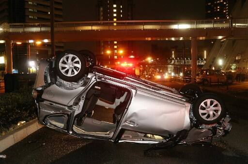 A car lies upside-down along a road after being blown by typhoon Jebi's strong winds in Osaka on September 4, 2018.
The strongest typhoon to hit Japan in 25 years battered the west of the country on September 4 with violent winds and heavy rain, killing six and injuring scores more. Powerful gusts ripped sheeting from rooftops, overturned trucks on bridges and swept a tanker anchored in Osaka Bay into a bridge to Kansai International Airport.
/ AFP PHOTO / JIJI PRESS AND AFP PHOTO / JIJI PRESS / Japan OUT