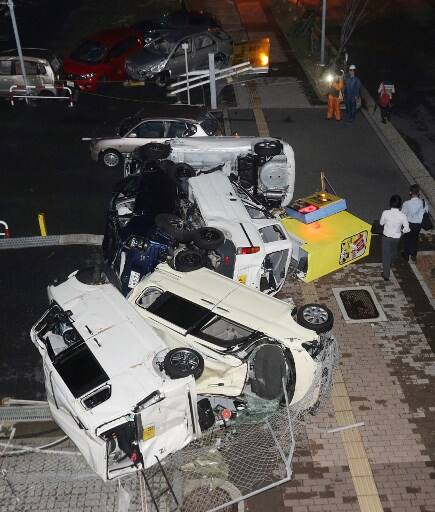 Damaged vehicles blown by strong winds from Typhoon Jebi are seen in Osaka on September 4, 2018, as the typhoon made landfall around midday in southwestern Japan.
The strongest typhoon to hit Japan in 25 years made landfall on September 4, the country's weather agency said, bringing violent winds and heavy rainfall that prompted evacuation warnings. / AFP PHOTO / JIJI PRESS / JIJI PRESS / Japan OUT