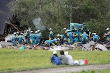 PICTURES: Rescue workers scrabble through mud to find stuck survivors as toll reaches 16 in Japan earthquake