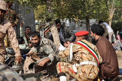The images from Iran show soldiers crawling on the ground as gunfire blazed in their direction. (AFP IMAGE)