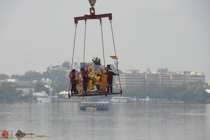 With a view to avoid pollution of natural water bodies, many civic bodies have also set up artificial ponds for immersion. Crane workers immerse an idol of the Hindu deity Ganesh in the Hussain Sagar Lake on the eleventh day of the Ganesh Chaturthi festival in Hyderabad on September 23, 2018. (AFP)