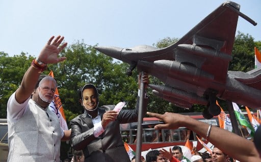 During the protest, the Congress party workers wear masks of Indian Prime Minister Narendra Modi and business tycoon Anil Ambani. (AFP IMAGE)