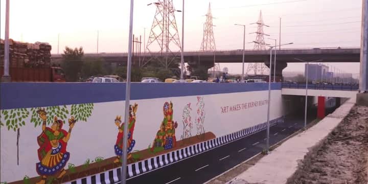 An underpass in Noida got a mesmerising overhaul and commuters passing through it on were pleasantly surprised to see it painted in multiple colours and with vibrant mythological motifs. Inaugurated by Union Culture Minister Mahesh Sharma, the art installation was jointly conceptualised by the Kiran Nadar Museum of Art (KNMA) and Noida Authority in order to promote arts in public sphere, IANS reported. /Image: Screengrab of video shared by Kiran Nadar Museum of Art on Facebook