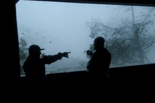 People watch as Michael makes landfall . (Photo by Brendan Smialowski / AFP)