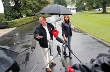 PICTURES: Trump leaves wife Melania getting drenched in rain as he hogs all of the umbrella