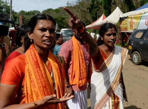 Indian Hindu devotees and activist react after being stopped by police personnel during the protest./(Photo by ARUN SANKAR / AFP)