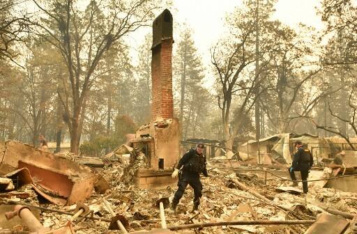 The fire that practically wiped off the town from the map, was so devastating that it left people charred to ashes. The authorities had to bring in a mobile DNA lab and forensic anthropologists to help identify the dead.(Photo by Josh Edelson / AFP)