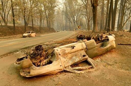 People were engulfed, cars melted down to metal carcasses, and power lines were gnawed by flames. It has virtually burned the town of Paradise to the ground and destroyed an estimated 6,700 buildings, most of which were homes. (Photo by Josh Edelson / AFP)