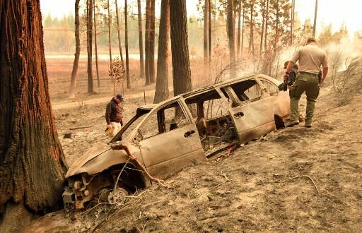 The wildfires raging in three different parts of the state, matching the state’s deadliest ever brush blaze 85 years ago. Dead bodies were found inside cars and in homes. Some bodies were found lying near vehicles, probably overcome by the smoke and fire before they could take over the steering to flee. (Photo by Josh Edelson / AFP)