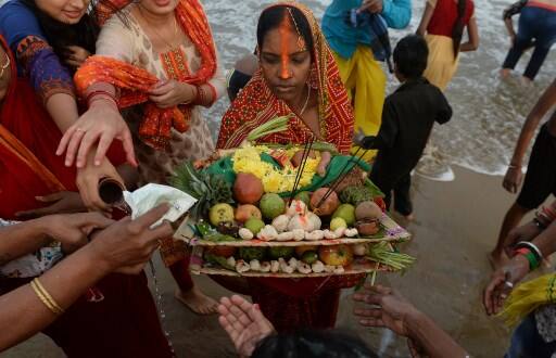 The riversides and ponds were decorated with paper flags, banners and colourful lights on the occasion. / AFP Image