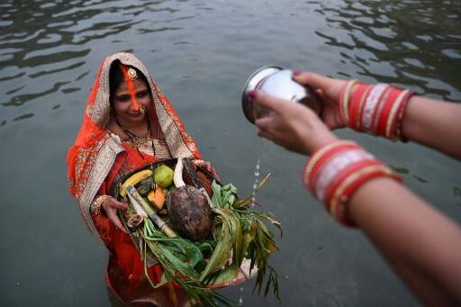 Various delicacies such as 'thekuwa' and rice pudding are prepared and served during the festival. / AFP Image
