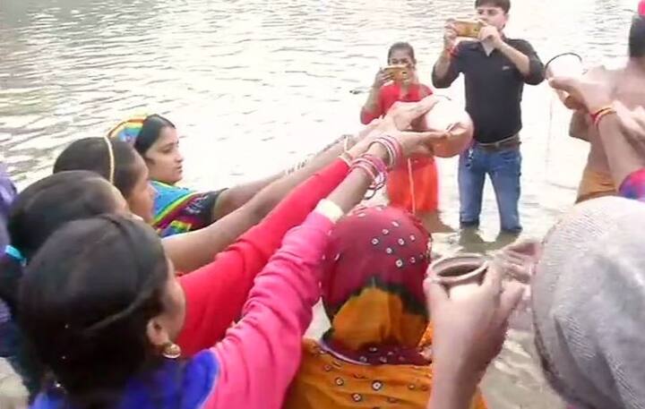 Devotees offer 'arghya' to the rising sun on the banks of Kuakhai river in Bhubaneswar, Odisha. Image: ANI