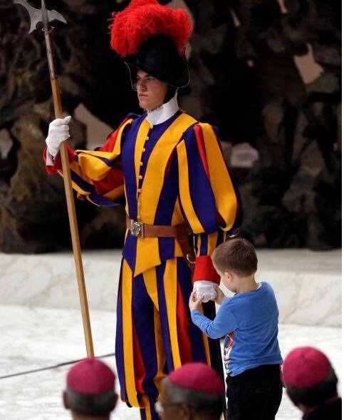 Pope Francis praised the freedom, albeit undisciplined, of a hearing impaired child who climbed onto the stage during his general audience to play. / AP IMAGE