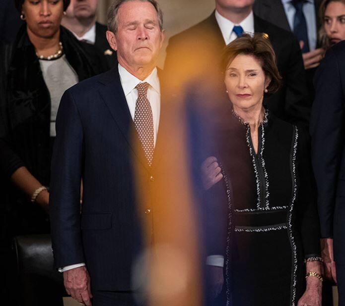 George W Bush and Laura Bush mourn the former President's death as his last remains were brought in Capital Rotunda/ Image: AP