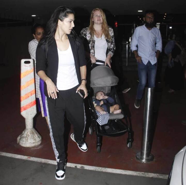While one of the twin kids was riding in the arms of the nanny, the other one made exit travelling in his pram.