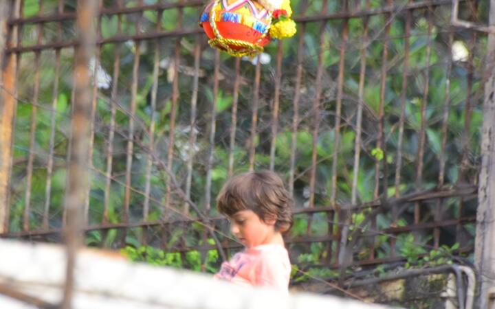 Looks like, the little one awaits Daddy dear to do the needful and here comes his father...