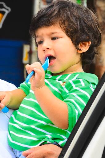 In this picture, we believe the little munchkin is lost in his own little world.