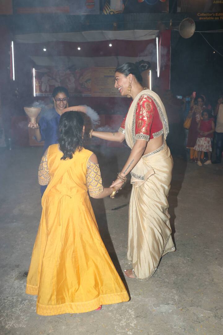 At one point she beckons her younger daughter to join her, who comes along, holds her mother’s hands and tries to imitate her mother’s steps