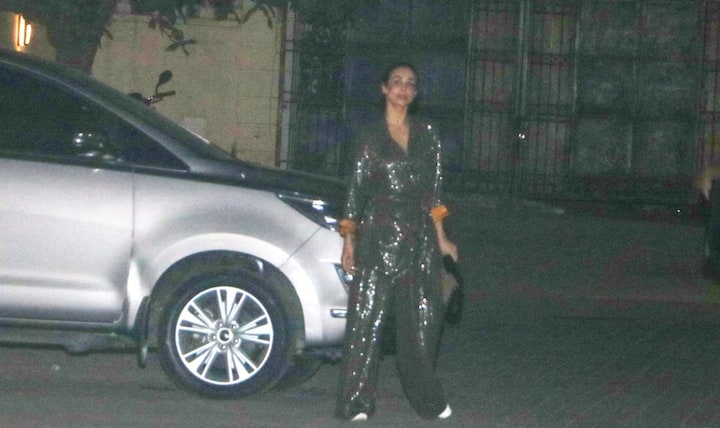 Malaika Arora arrived in a shimmery pantsuit.