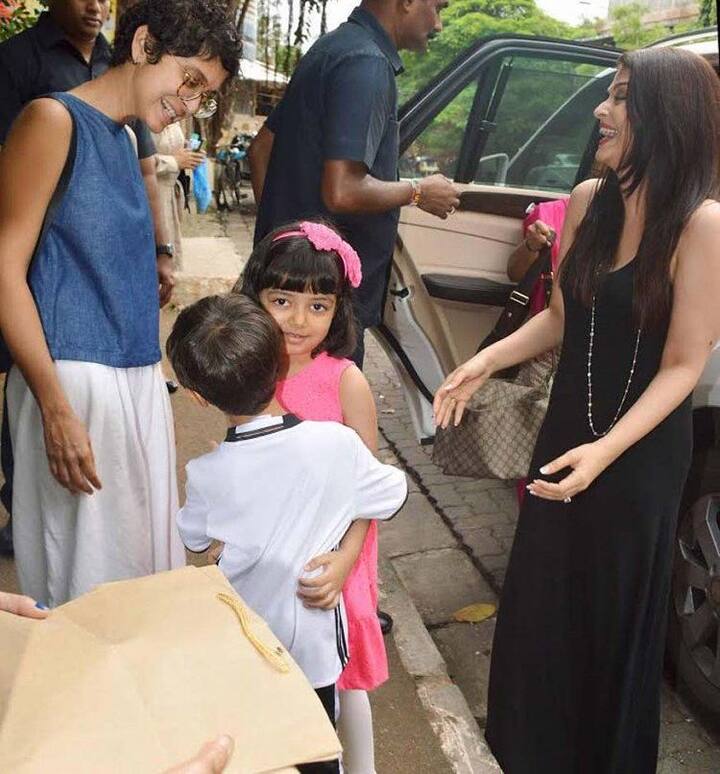 Aaradhya and Azad hug each other and Mommies Aish and Kiran look