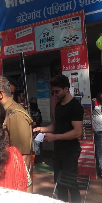 Gurmeet seen standing here with his bank documents waiting for his turn at the bank