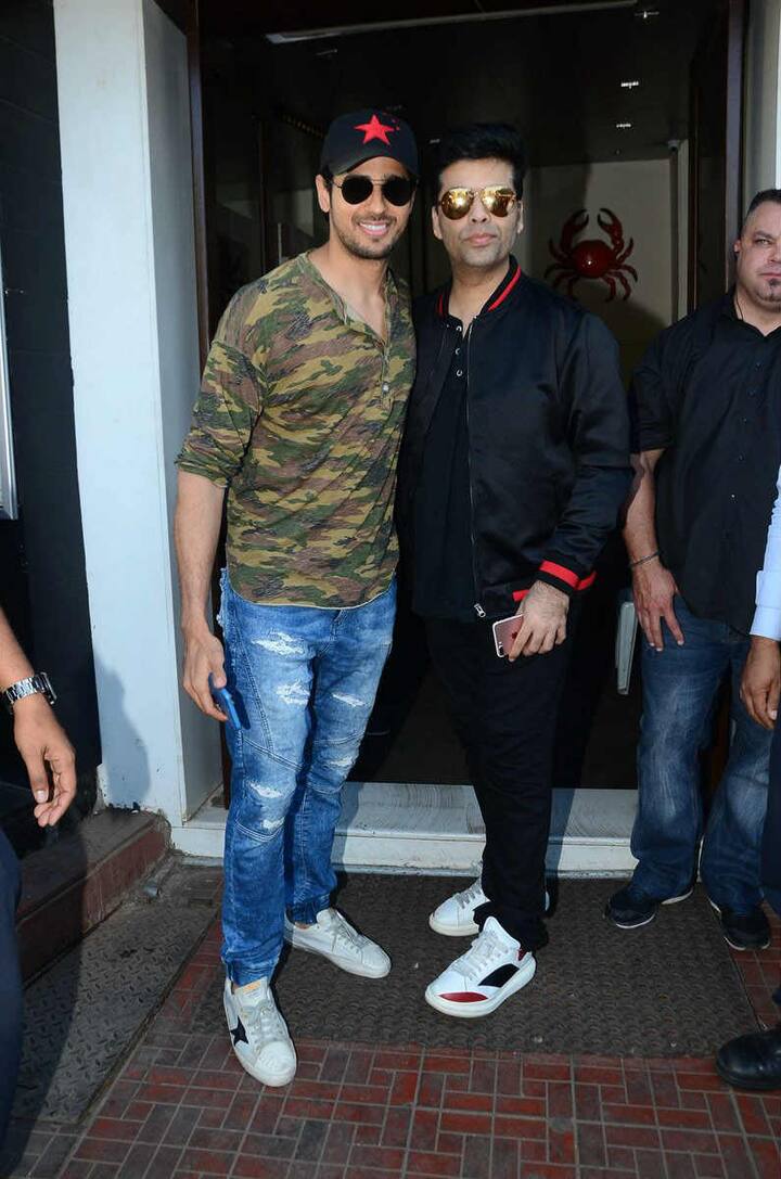 Siddharth Malhotra and Karan Johar posing for the media.