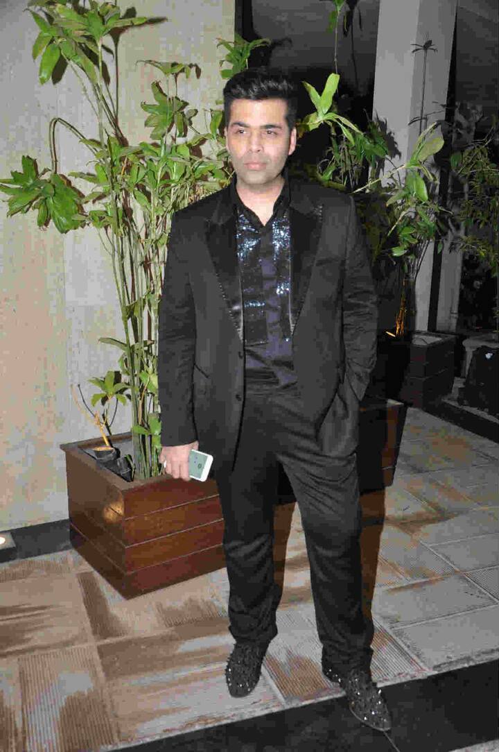 Karan Johar was seen in black suit and Shimmery shoes.