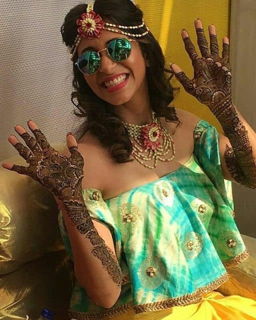 Kishwer broke the traditional and donned the avatar that totally reflects her bindaas personality. Kishwer was wearing this yellow and green dress with the super cool glares at her mehendi(Photo: Instagram)