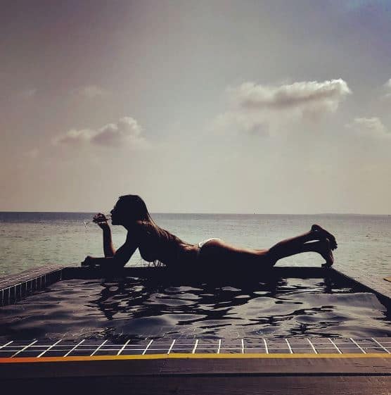 On Wednesday, Nia posted this pic of herself in a two piece bikini with a glass of wine in her hand