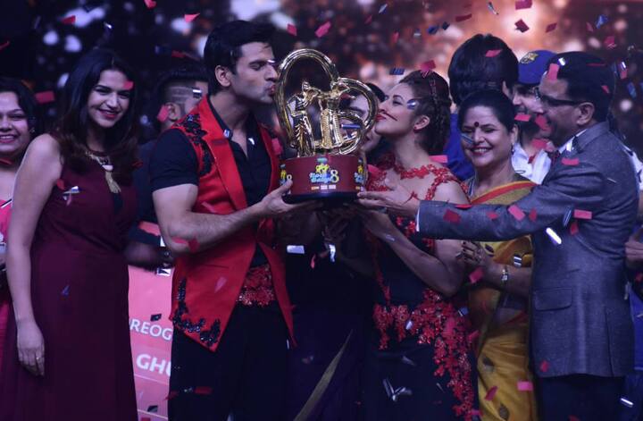 The couple celebrated their winning moment by kissing their prized possession! 