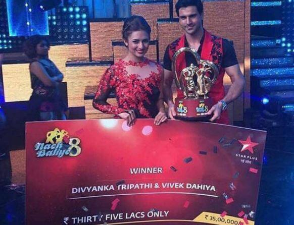 Divek with their winning amount cheque