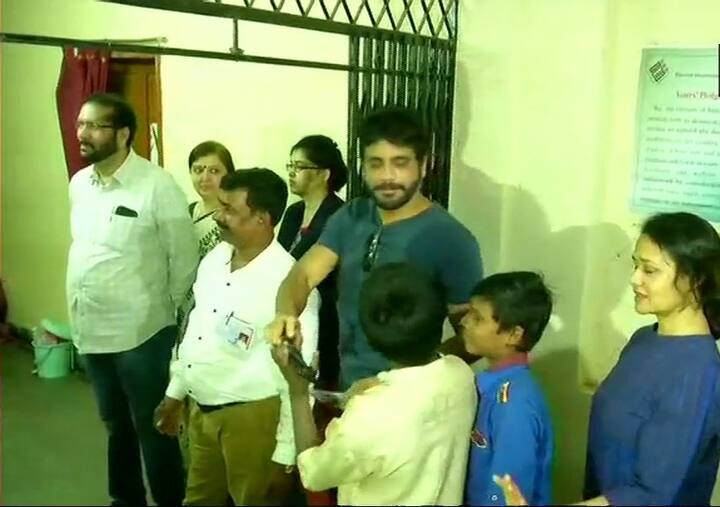 Actor Akkineni Nagarjuna and his wife & actor Amala Akkineni stand in a queue to cast their votes/ All images: ANI