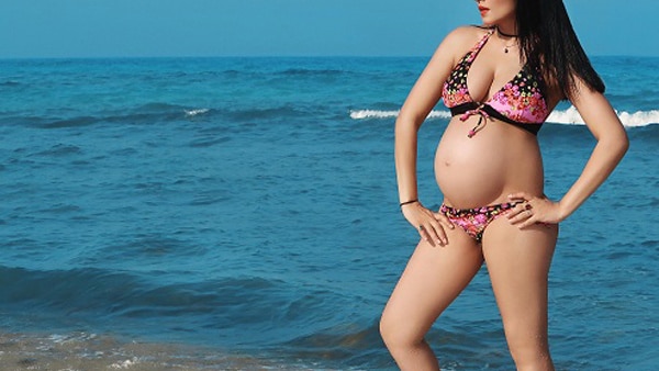 FIRST PIC: Celina Jaitley flaunts her huge baby bump posing in a bikini with a message 