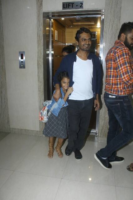 The shy little star-kid was hiding her face with father's date and was smiling throughout Nawazuddin's photo-session. (Photo: Manav Manglani)