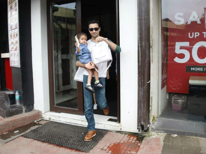 Wrapped in his daddy's arms Imara was wearing a cute denim frock and black shoes looking like a doll! 