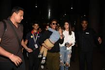 IN PICS: Doting DAD Shah Rukh Khan carries a SLEEPY AbRam at the Airport as he returns back from Duabi with co-star Anushka Sharma!