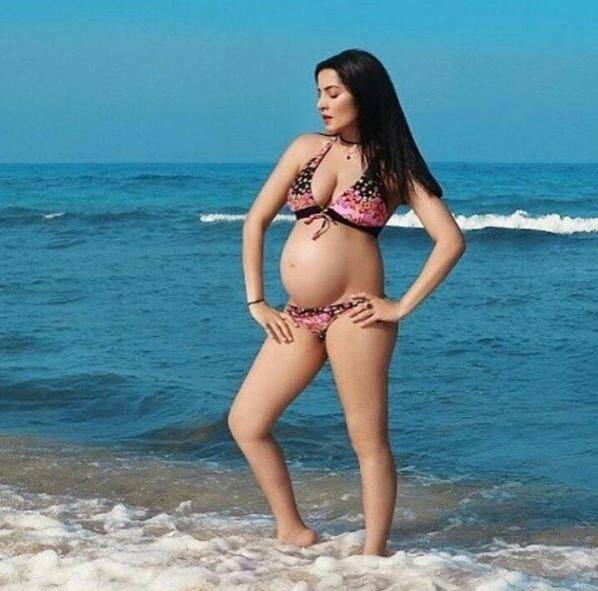 In-fact Celina broke her pregnancy news with this pic beside the sea in a two piece bikini flaunting her bare bump