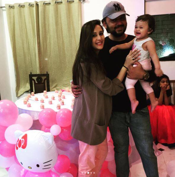 Chahatt and hubby posing with their daughter at the bash
