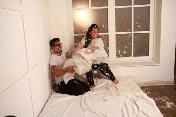 Where the couple is indulged in a pillow fight in their matching outfits 