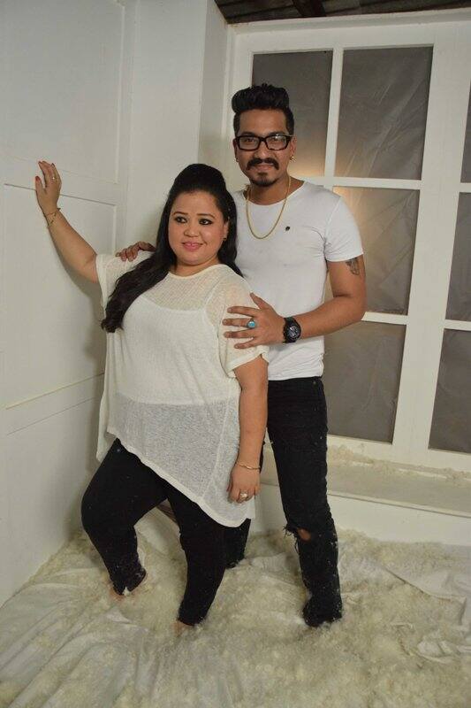 Bharti and Harsh are twinning in monochromes for the shoot with a white backdrop. 