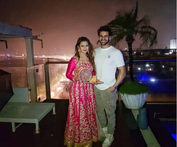 Divyanka was looking pretty in a heavy pink anarkali styled suit standing beside hubby Vivek as the duo celebrated Karwa Chauth