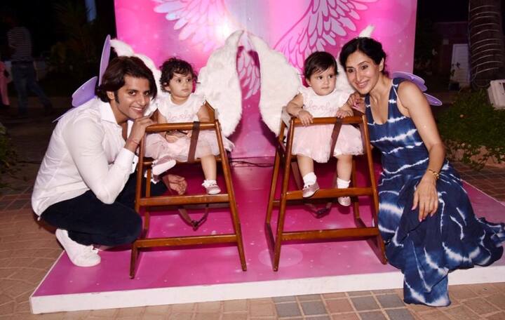 The baby girls looked cute as they posed with their parents on their birthday party.