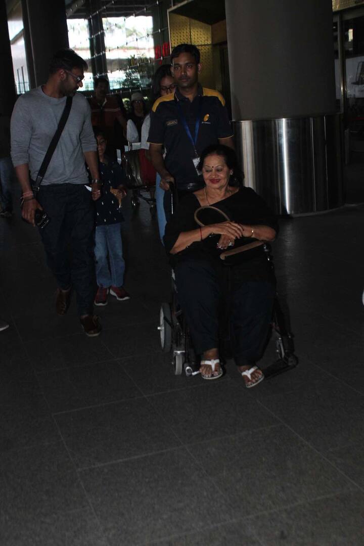 Ajay made his exit from the airport and he was spotted with his Mom Veena who was on the wheel chair while both kids were following them behind.