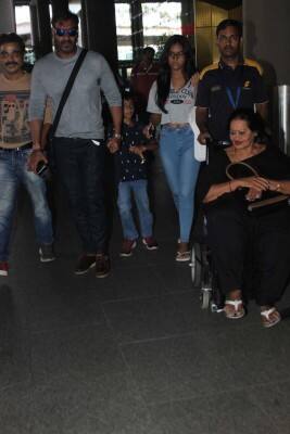Ajay with Nysa and Yug and his mother Veena at Mumbai airport on their return from Goa. Kajol had come separately a day earlier.