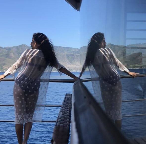 She shared another pic of herself chilling in a black bikini with the transparent shirt