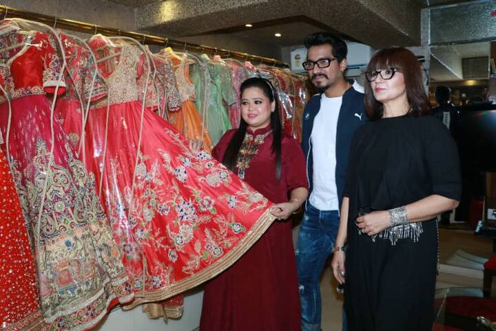 Bharti & Haarsh posing with Neeta Lulla at her store